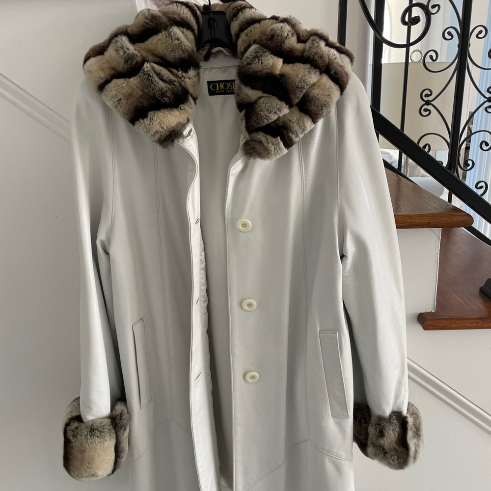 White/pearl leather coat with black and white Rex, wide collar arms trim.